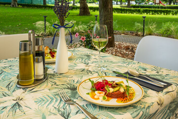 Gourmet tartare dish on outdoor restaurant table
