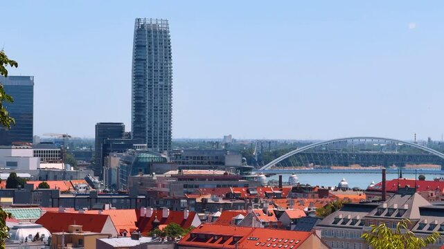 Orange roofs of the buildings in the old town of Bratislava, Slovakia. New city and the Appolo Bridge at backdrop.