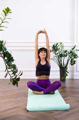 Sporty woman doing and practicing yoga at home. Healthy lifestyle concept, well-being, hobby....