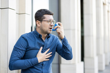 A man uses an inhaler, highlighting respiratory distress and healthcare solutions in an urban...