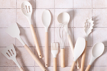 kitchen set spatulas ladle on tile background