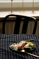 Salmon fish steak grilled, avocado and fresh vegetable salad. Ketogenic diet. Low carb high fat breakfast. Healthy food concept.