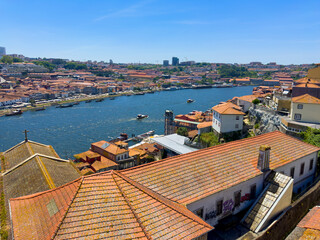 Panoramic view of Porto and Vila Nova de Gaia with Douro River, sailing boats, red tile rooftops in
