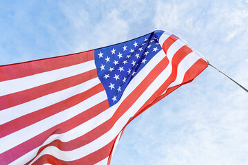 American flag fluttering in the wind against the sky