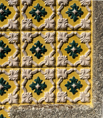Tile facade close up, beautiful ceramic surface, geometric ornamental design, bright floral motif,