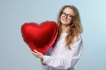 Female Doctor Holding Red Heart Balloon Promoting Heart Health and Medical Care