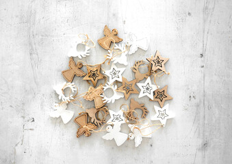 handcrafted wooden Christmas ornaments in white and brown tones, featuring traditional festive...