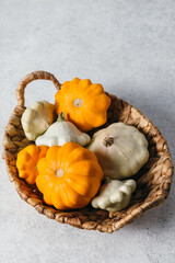 Autumn composition for Thanksgiving Day with variety of pattypan squashes on white kitchen table. Flat lay, top view, copy space for text.