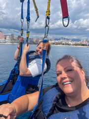 Benidorm, Spain - May 12, 2025: Midlife women enjoying paragliding adventure over the beautiful...