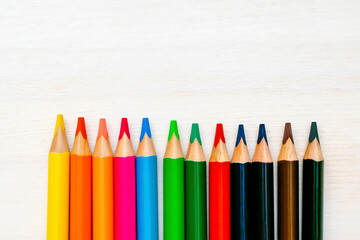 Colorful pencils in raw, pastel crayons. Creativity creation process. Artist's stuff on white table.Top view Flatlay of drawing supplies