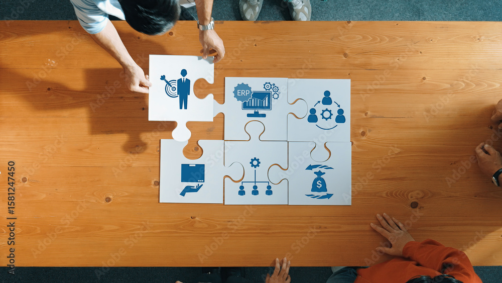Poster a top-down view of a team collaboratively assembling puzzle pieces, each representing different aspe