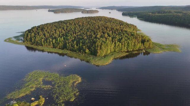 Northern P&auml;ij&auml;nne Finland: Aerial View of V&auml;h&auml;-Urtti Island at Sunset with Sunlit Green Pines