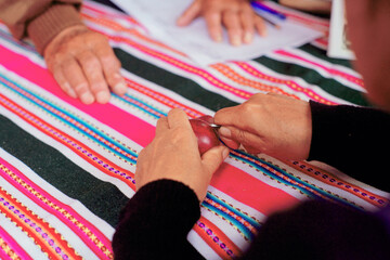 A woman's hands working on a Peruvian carved mateshowcasing traditional craftsmanship Peruvian ,...