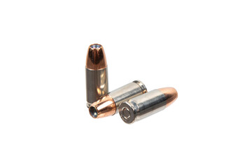 Three hollow-point pistol cartridges on on a transparent back
