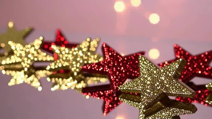 Sparkling gold and red star garland with festive bokeh glow - Powered by Adobe