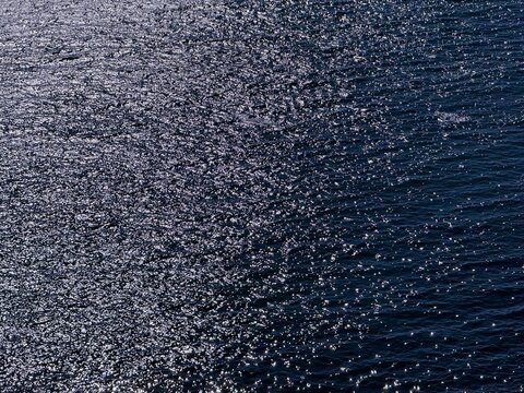 Glittering sea water surface background.