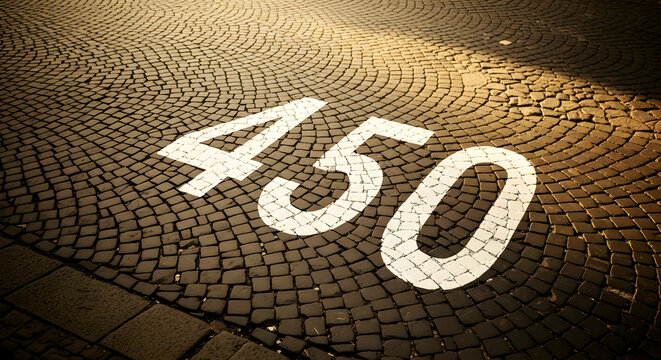 Image depicting number four hundred and fifty painted on cobblestone street surface