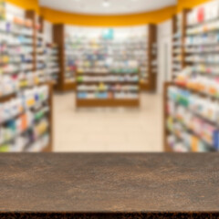 Empty wooden counter with copy space in front of blurred pharmacy shelves with medicines....
