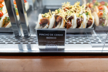 Bao bun stuffed with Iberian pork and wok vegetables, topped with BBQ sauce and served with crispy...