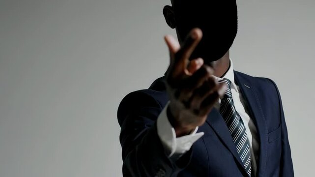 Businessman in blue suit gesturing forward with assertive confidence