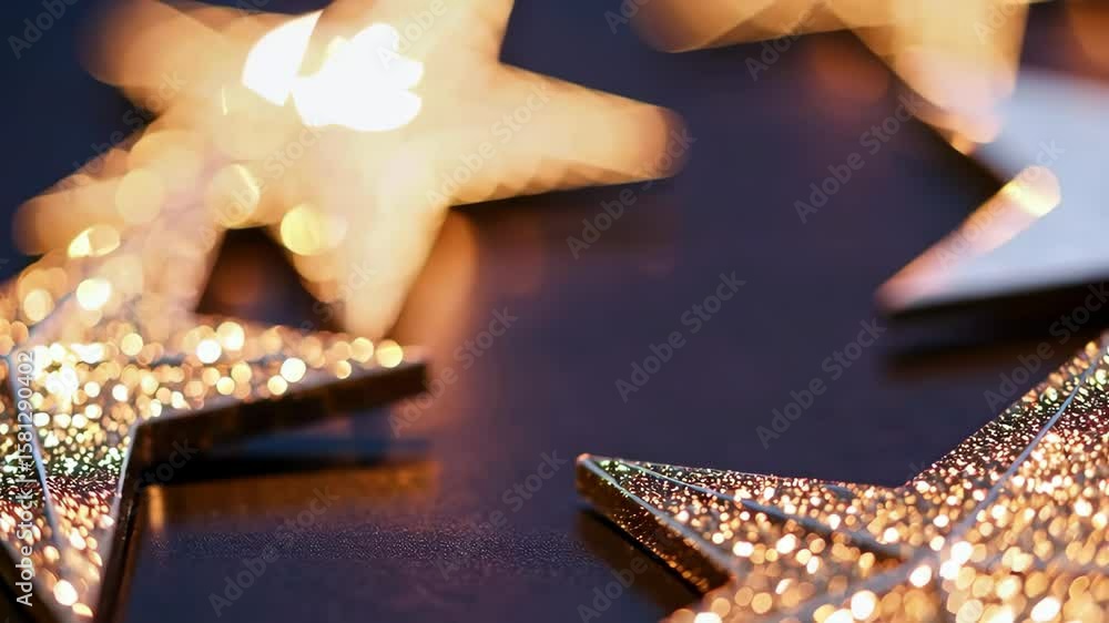 Wall mural shimmering gold stars in motion on dark surface with soft bokeh effect