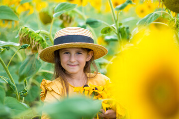 little girl in sunflowers in a field
