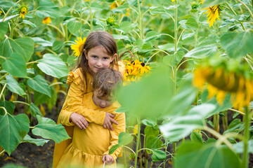 little girls in sunflowers in a field