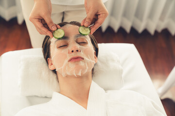 Serene daylight ambiance of spa salon, woman customer indulges in rejuvenating with luxurious...