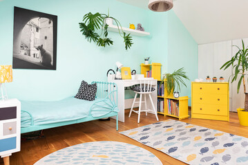 Cozy interior of room child with pastel color on the wall and yellow color in decor. Room in the...