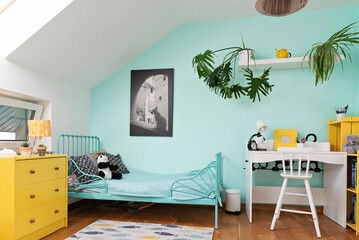 Cozy interior of room child with pastel color on the wall and yellow color in decor. Room in the...