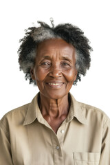 A smiling senior African woman with graying, textured hair gazes directly at the camera in a portrait.