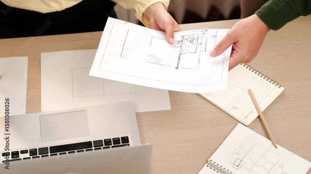 Poster video of clever architect and smart engineer with laptop discussing about a detail on blueprint for 