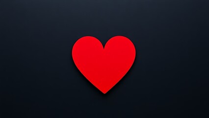 Minimalist red heart on dark textured background with directional lighting