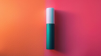 Obraz premium A green cosmetic tube with a white cap lies on a split pink and orange background