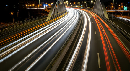 Obraz premium Night Highway Car Light Trails on the Bridge with City Illuminations