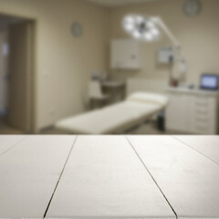 Empty wooden table with copy space in front of blurred doctor's office interior. Preventive care,...