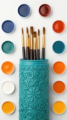 Artist's colorful paint and brush set with watercolors for creative drawing and school art