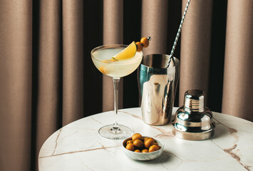 refreshing Mexican Martini with olives and citrus garnish in a stylish bar setting