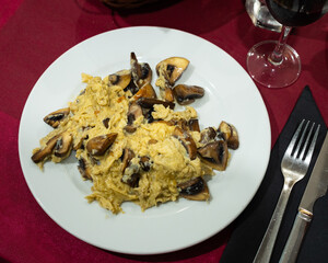 Simple and healthy dish is served for breakfast - fried scrambled egg with champignon mushroom