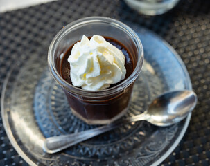 Italian dessert panna cotta with layer of pureed wild berries. Vanilla milk jelly in transparent glass.