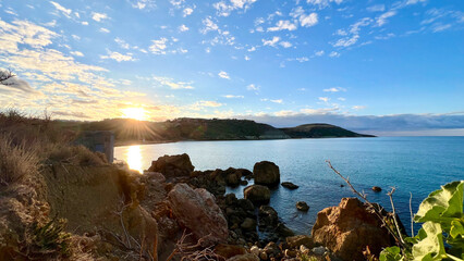 Golden sunrise illuminating picturesque coastline in malta