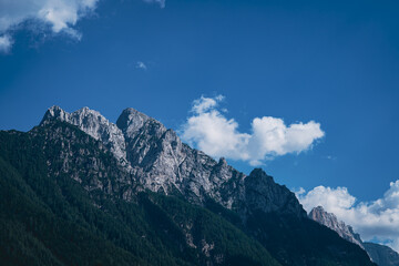 Beautiful Mountain Peaks, Rocky, with Sky Filled with Beautiful White Clouds