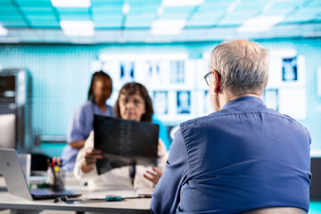 Female doctor evaluating x ray imaging test findings to provide the diagnostic report for a sick...