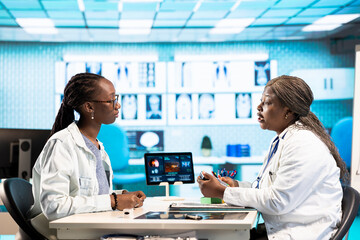 African american girl paying for prescribed pills and medicaments on POS terminal, purchasing...