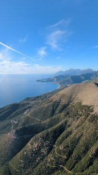 Powered paragliding paramotor flying over Albanian coast mountains and beaches aerial panorama landscape view,Albania,Balcan