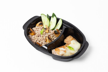 Buckwheat with sautéed mushrooms, baked chicken fillet topped with cheese, and fresh cucumber slices on a plate against a white background