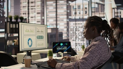 African american staff analyzing financial data for strategic planning, debating resource...