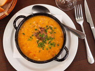 Traditional Asturian rich beans stew Fabada with pork shoulder, morcilla and chorizo
