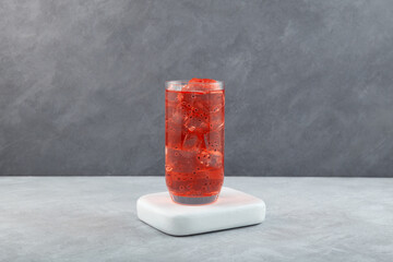 Pomegranate Basil Seed Drink or Anar Basil Seed Sherbet in tall glass cup. Sweet, flavored...