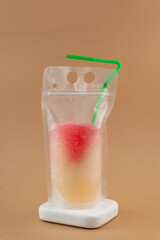 Citrus lychee iced drink or slushy in spill-proof plastic bag. Granizado or Shaved ice in PET pouch. Refreshing summer take away drink